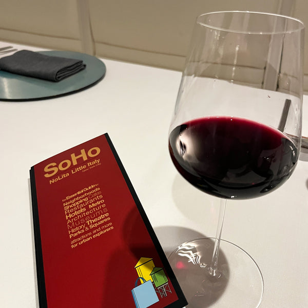 SoHo Red Maps street map at a restaurant table with a glass of wine